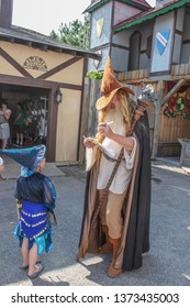 Muskogee USA 5-20-2010 A Man In A Wizard Costume Signs His Autograph For A Little Kid With A Wizard Hat