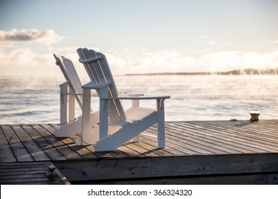Muskoka chairs on a dock over looking lake Huron and Georgian Bay