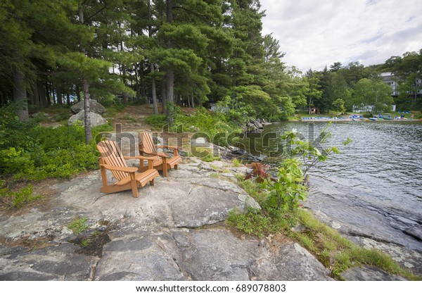 Muskoka Chairs On Rock Formation Facing Stock Photo Edit