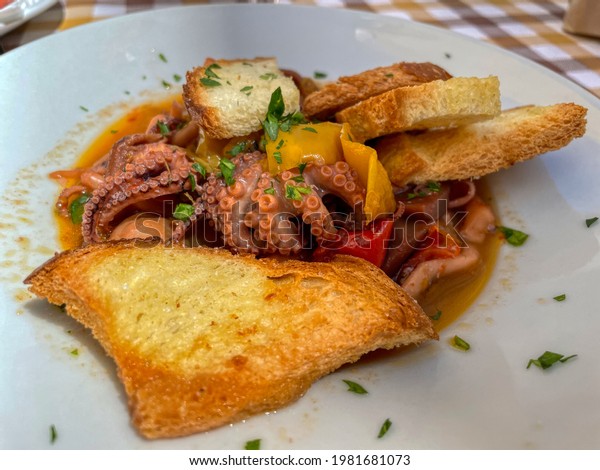 Musky octopus with peppers and croutons. Typical\
Apulian cuisine. Puglia,\
Italy