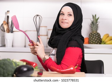 Muslim Arab Girl In Kitchen Cooking Some Meal.