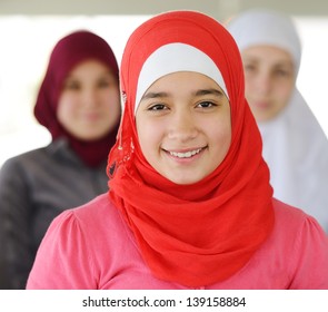 Muslim and Arabic girls standing together in line row