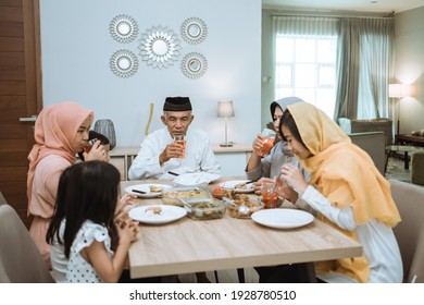 Muslim Asian Family And Grandparents Having Break Fasting On Ramadan. Iftar Dinner Break