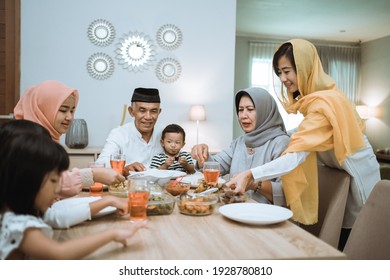 Muslim Asian Family And Grandparents Having Break Fasting On Ramadan. Iftar Dinner Break