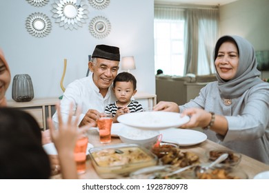 muslim asian family and grandparents having break fasting on ramadan. iftar dinner break