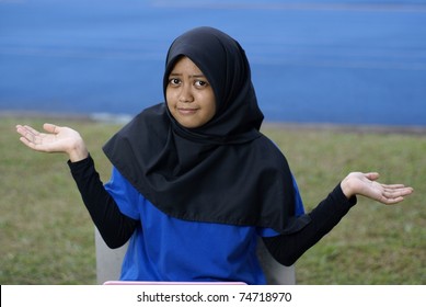 Muslim asian girl with puzzled blase look