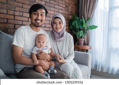 Muslim Asian Parent Playing At Home With Their Baby