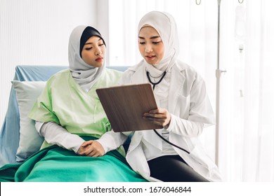 Muslim asian woman doctor service help support discussing and consulting talk to muslim woman patient and check up information at health medical care trust concept in hospital.healthcare and medical