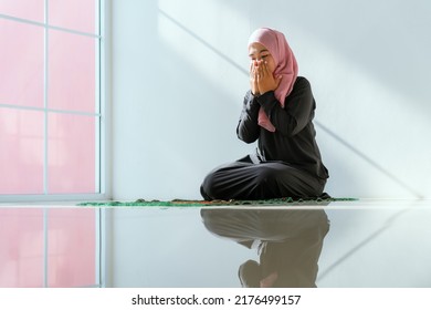 Muslim Asian Woman Praying In A House In The Morning Sunlight And A Window.