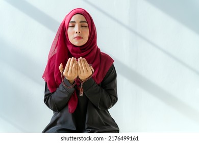 Muslim Asian Woman Praying In A House In The Morning Sunlight And A Window.