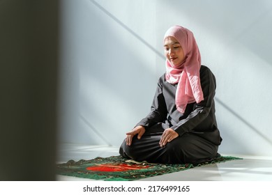 Muslim Asian Woman Praying In A House In The Morning Sunlight And A Window.