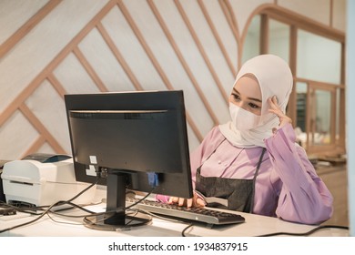 Muslim Asian Woman Working Using Pc While Wearing Medical Face Mask