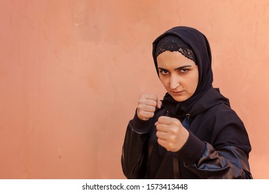 Muslim Boxer Woman In Islamic Sportswear. Muslim Fighter Boxer Posing Doing Exercises. Healthy Lifestyle, Sport In Islamic Countries, Women Rights Concepts