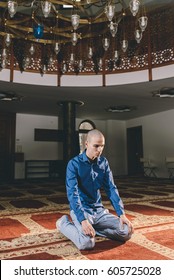 Muslim Boy Kneeling Humbly In Prayer