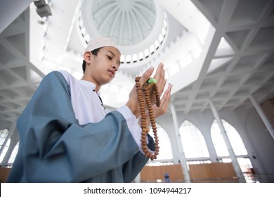 Muslim Boy Praying In Mosque