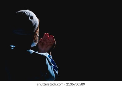 Muslim boy in white session lift two hand for praying ,isolated on black background.concept for Ramadan, Eid al Fitr, eid ad-ha, meditation, islamic praying