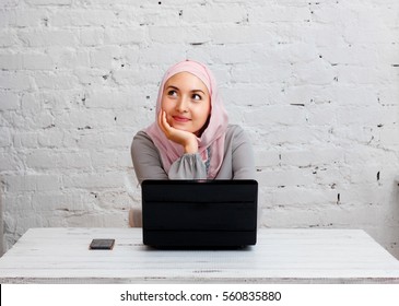 muslim business lady working on computer in the office, and thinking