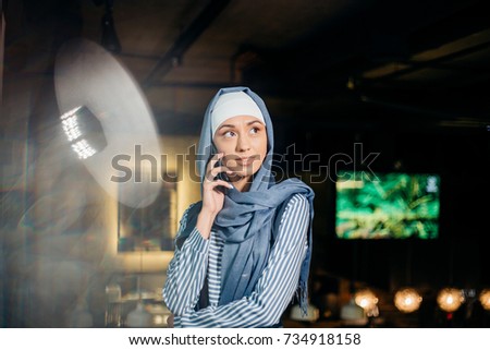 Muslim business woman on phone over conference
