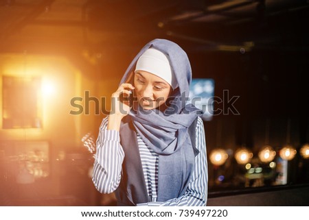 Muslim business woman on phone over conference