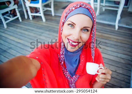muslim caucasian woman taking selfie
