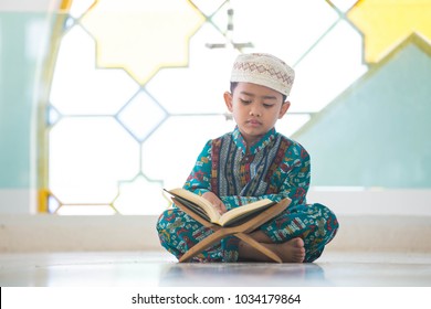 Muslim Children Read The Quran Reading - Holy Book Of Muslims Around The World Put On Wooden Boards