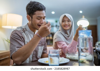 Muslim Couple Wake Up Early To Have Sahur Or Suhur Breakfast For Fasting. Clock At Foreground Showing The Time