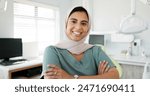 Muslim dentist, woman and happy with face, arms crossed and pride for career, healthcare and wellness. Person, dentistry doctor and happy with hijab for faith with confidence in medical workplace