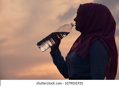 Muslim Drinking Water At Sunset