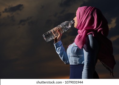 Muslim Drinking Water At Sunset