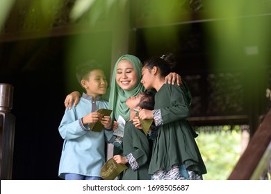 Muslim Family, Children Received Money Packet As Blessing, Hari Raya Eid Al-Fitr Concept. 