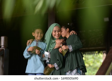 Muslim Family, Children Received Money Packet As Blessing, Hari Raya Eid Al-Fitr Concept. 