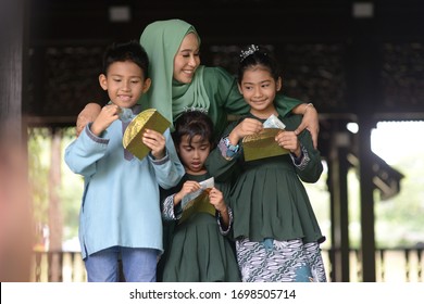 Muslim Family, Children Received Money Packet As Blessing, Hari Raya Eid Al-Fitr Concept. 