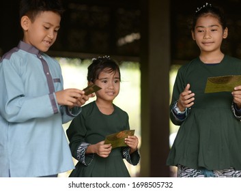 Muslim Family, Children Received Money Packet As Blessing, Hari Raya Eid Al-Fitr Concept. 