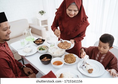 Muslim Family Enjoy Eating When Break Fasting Together At Home