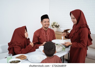 Muslim Family Enjoy Eating When Break Fasting Together At Home