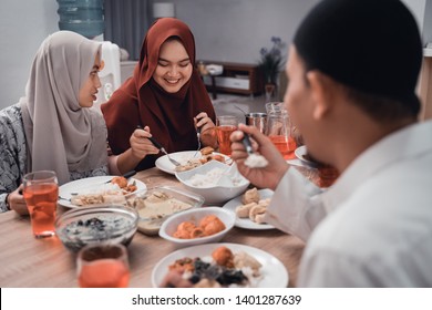 Muslim Family Enjoy The Iftar Meal Dinner Together In Dining Room