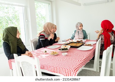 Muslim Family And Friends Gathering Together At Home For Eating Dinner. High Quality Photo