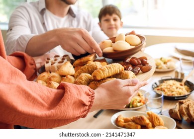 Muslim family having breakfast together. Celebration of Eid al-Fitr