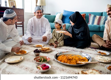 Muslim Family Having Dinner On The Floor