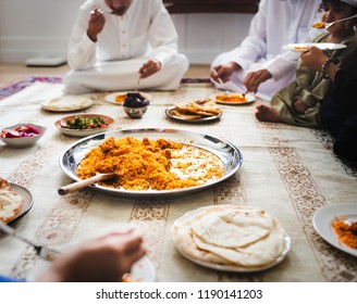 Muslim Family Having Dinner On The Floor