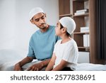 Muslim family praying together during ramadan kareem at home symbolizing faith spirituality and religious devotion father teaching son in islamic traditions with koran in hand