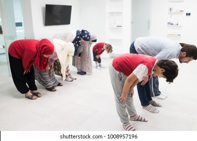 Muslim Family Praying Together At Home