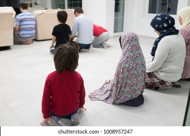 Muslim Family Praying Together At Home