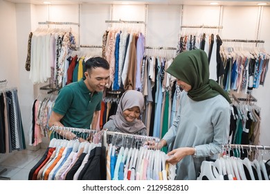 Muslim Family Shopping Together At The Mall Buying Some New Clothes