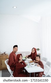 Muslim Family Sit To Eat When Breaking Fast Together At Home