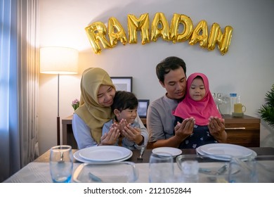 Muslim Family Thanking God For The Food During Break The Fast