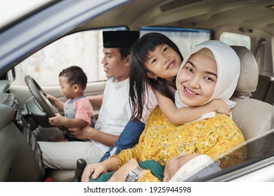 Muslim Family Travel By Car During Eid Mubarak Celebration. Asian People Going Back To Their Hometown