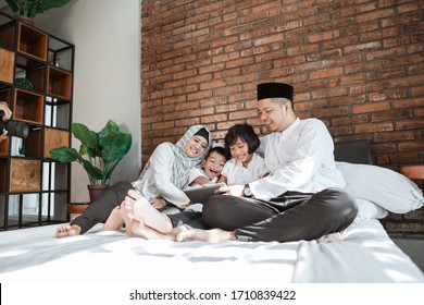 Muslim Family Using Tablet Together During Eid Mubarak Stay Home