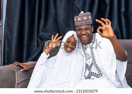 muslim Father and daughter wearing african attire expressing happiness. Daughter wearing hijab radiating positive emotions