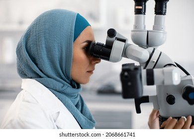 Muslim Female Dentist Doctor Using Dental Microscope At Workplace In Clinic, Closeup Shot Of Islamic Stomatologist Lady In Hijab Making Research With Modern Medical Equipment In Hospital, Closeup